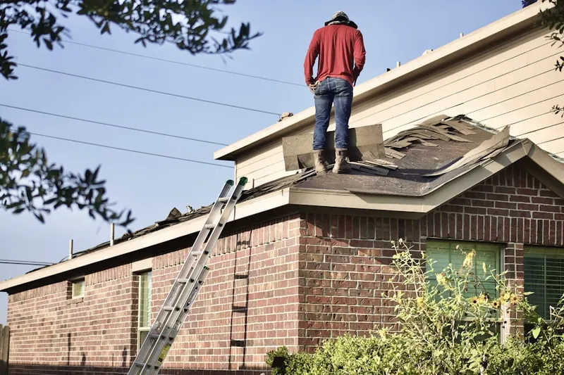 Professional roofer working on a residential roof in Lake Monticello